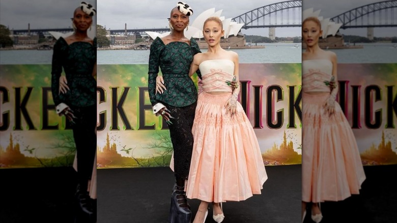 Ariana Grande posing with Cynthia Erivo in Wicked-themed clothes outside the Sydney Opera House.