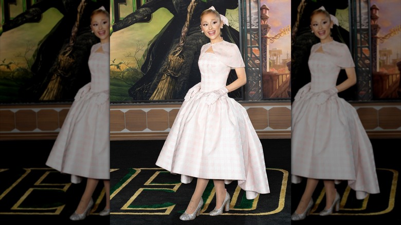 Ariana Grande posing in pink gingham dress at the premiere of "Wicked"