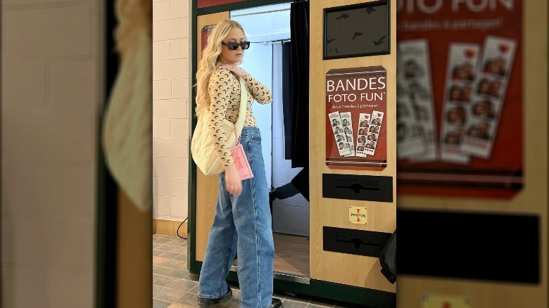 A woman wearing wide denim jeans
