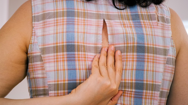 Woman finding a hole in her dress