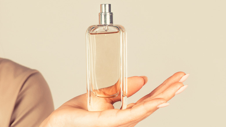 woman holding a perfume bottle