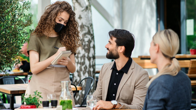 Man smiling at waitress