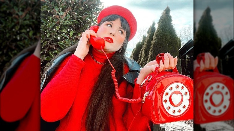 Woman carrying red phone purse