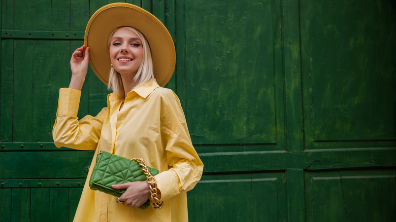 green quilted purse lady in yellow