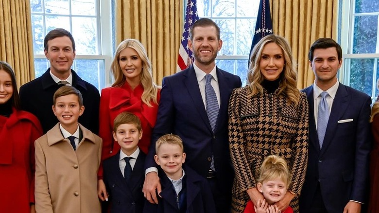 Ivanka Trump wearing a red coat while posing for a picture at the White House