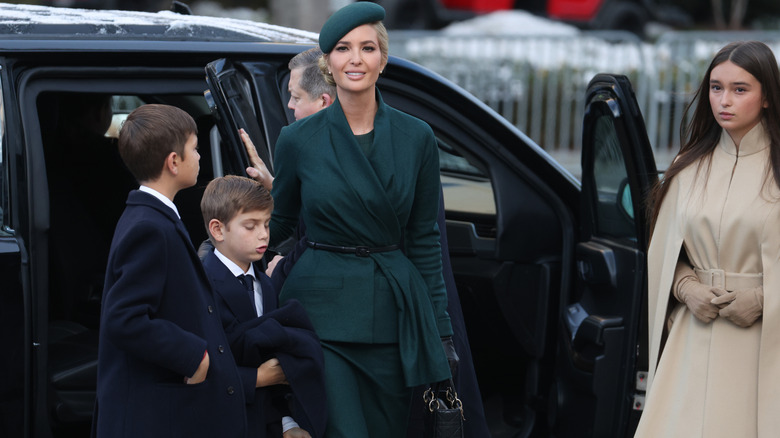 Ivanka Trump wearing dark green while getting out of a car