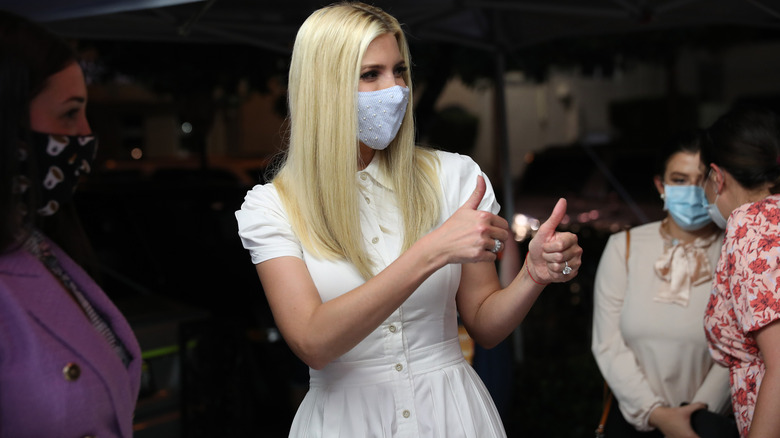 Ivanka Trump wearing mask while wearing a white dress