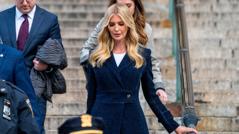 Ivanka Trump walking down stairs in a blue coat