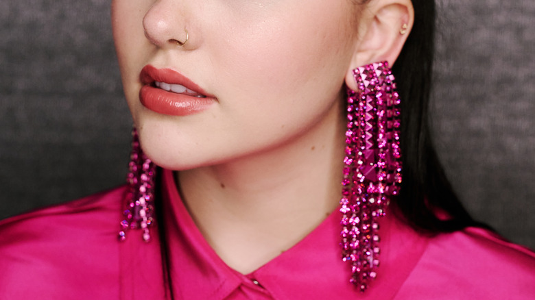 A woman with long chandelier earrings