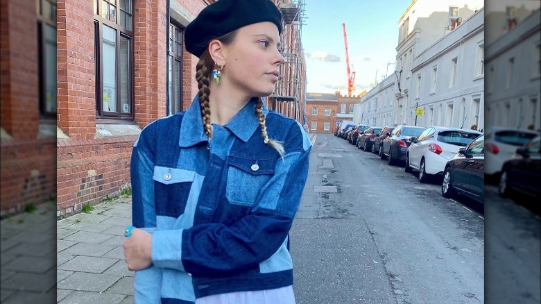 A woman wearing a patchwork denim jacket