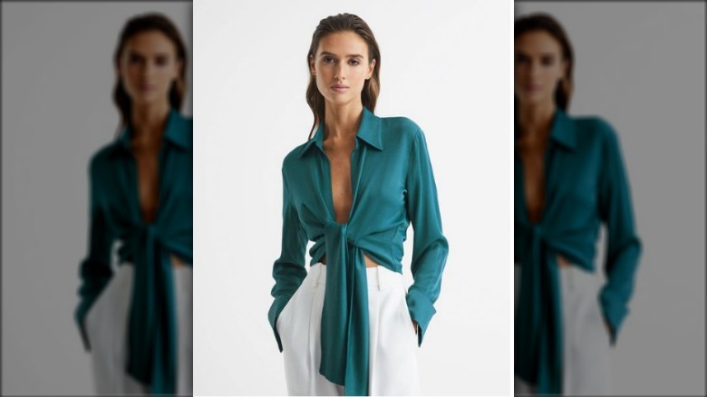 Model wearing teal tie-front blouse