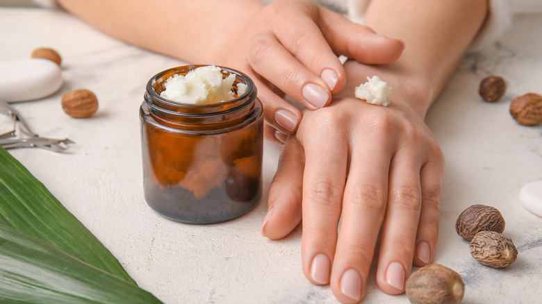 woman applying lotion to hands