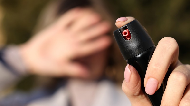 Woman using pepper spray