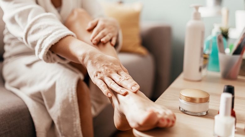 woman applying moisturizer