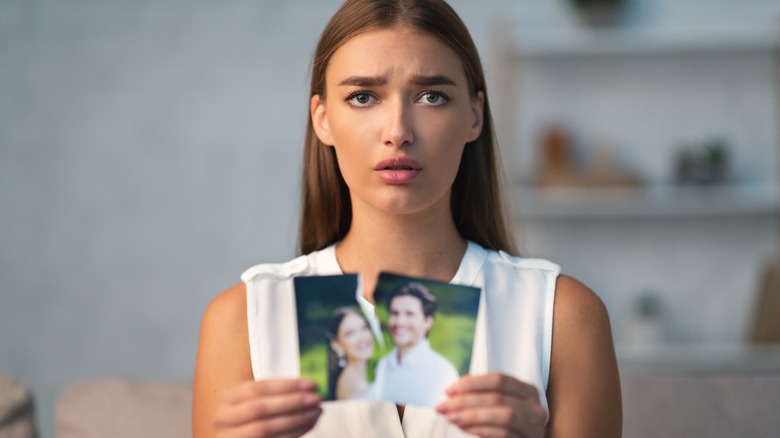 woman ripping photo of ex