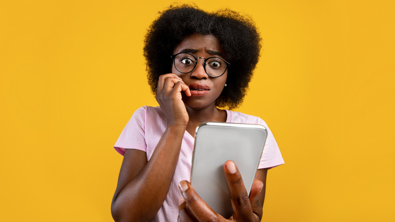 Woman nervously checking her phone