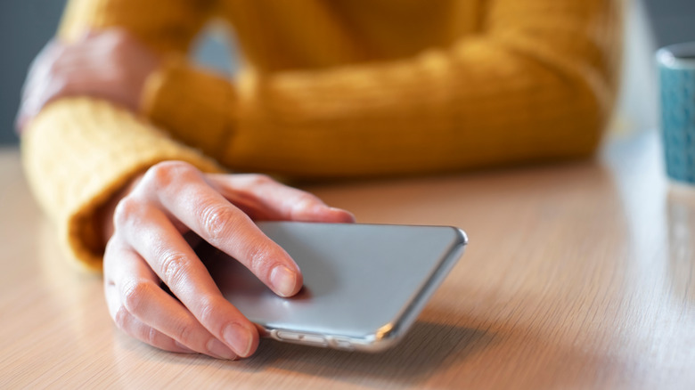 woman putting phone down