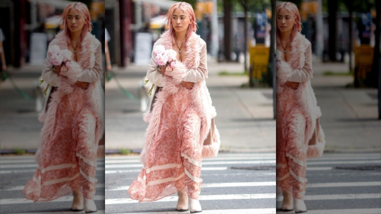 woman wearing maximalist pink coat, dress, hair