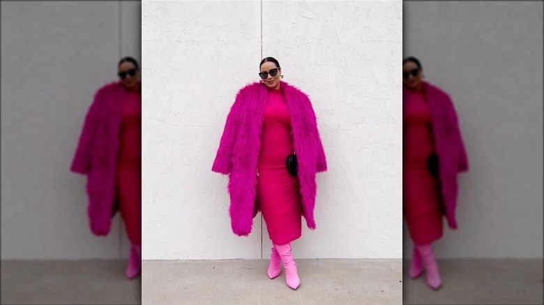 woman wearing pink feathered jacket over pink dress