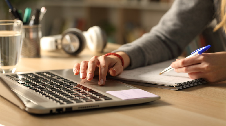 woman typing on laptop