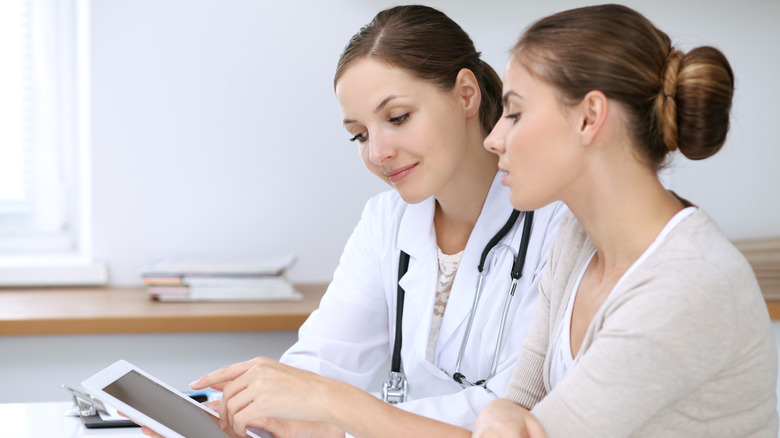 doctor and patient discussing on tablet