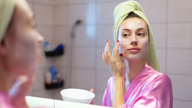 woman applying face mask