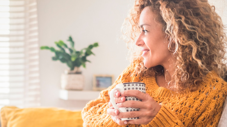 woman drinking tea and smiling