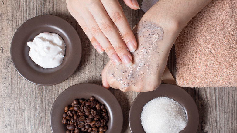 Woman applying a scrub to her hand