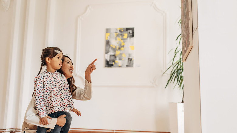 excited woman and child viewing art