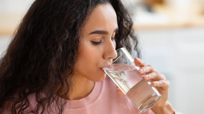 woman drinking a glass of water