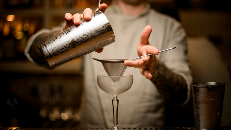 pouring wine through a strainer