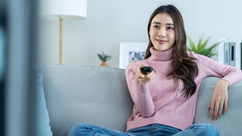 smiling woman watching TV