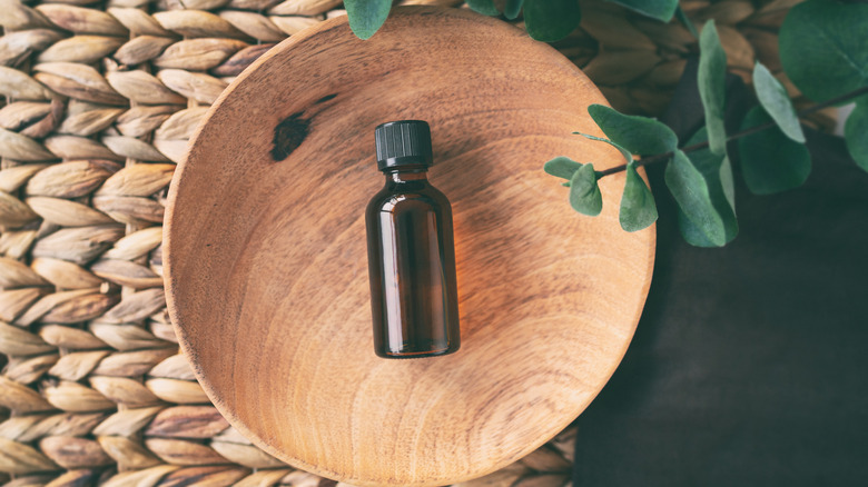 tea tree oil in wooden bowl