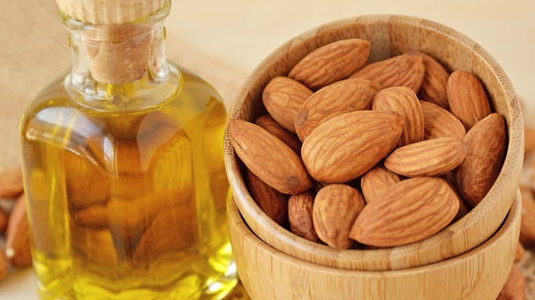 Almonds and a bottle of almond oil