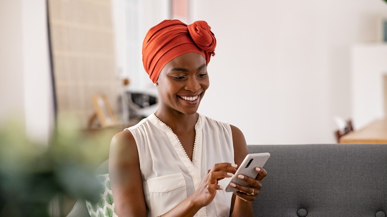 woman wearing turban looking at phone