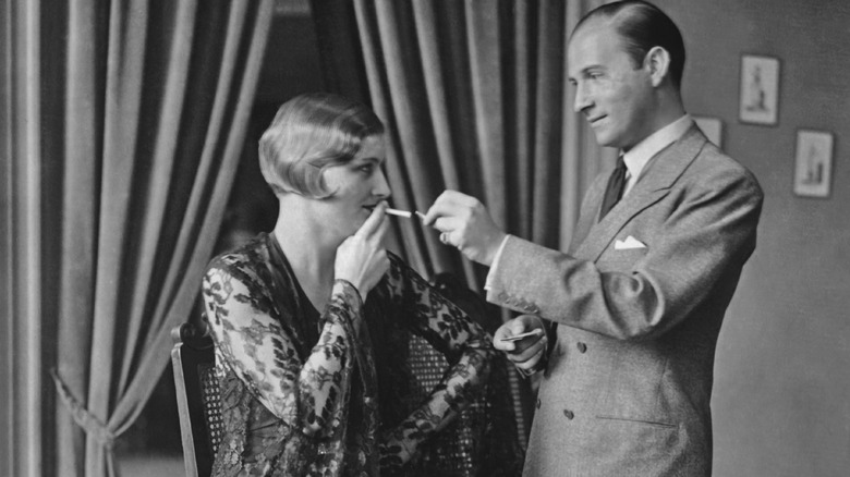 1920s man lighting woman's cigarette