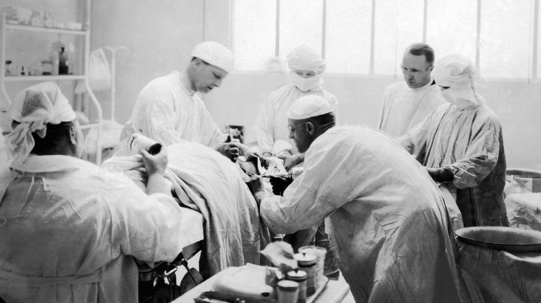 surgeons gathering around surgery table