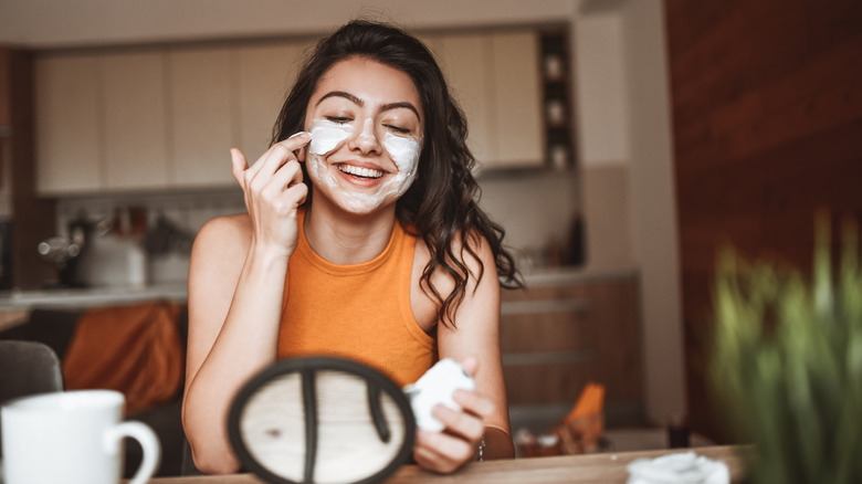 woman using skincare products