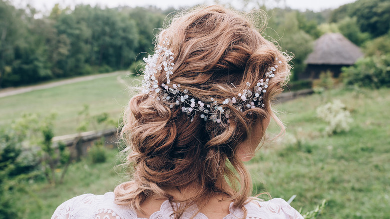 Messy updo with braid and floral crown