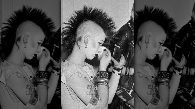 Punk woman wiping makeup off