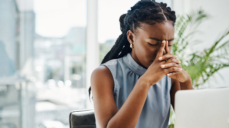 woman feeling stressed at work