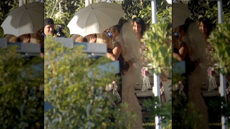 Jennifer Lopez in her wedding dress being hidden by her team