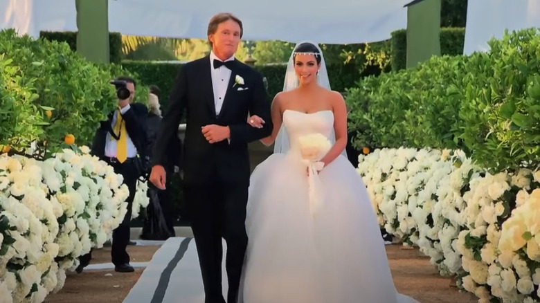 Kim Kardashian being walked down the aisle in her Vera Wang dress