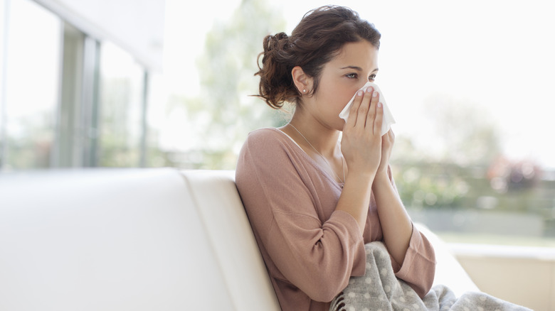 Woman blowing her nose 