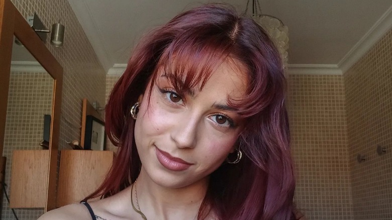 A woman with cherry red hair