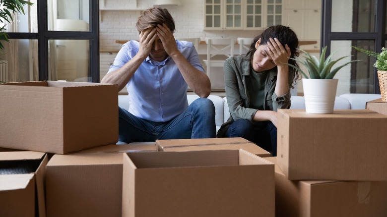 Angry couple surrounded by moving boxes