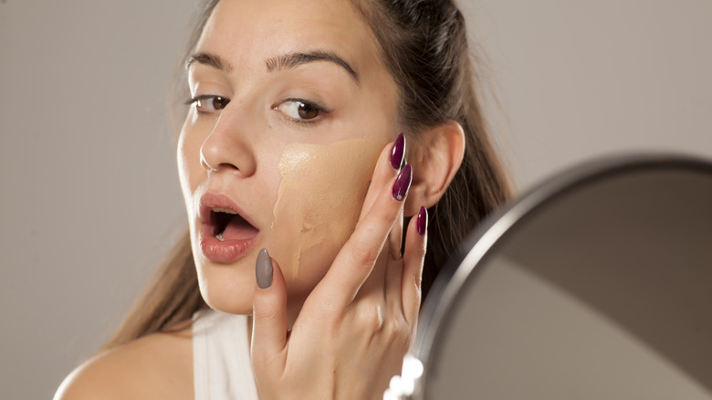 Woman applying foundation