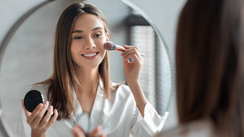 Woman applying makeup