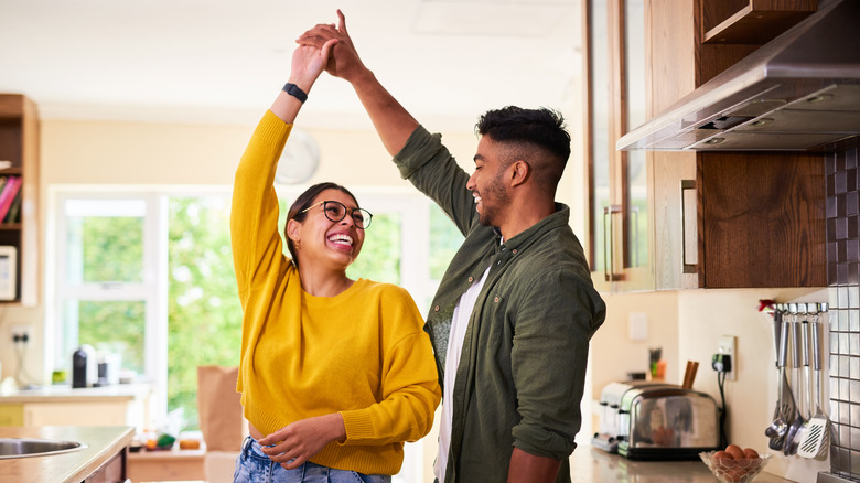 Couple dancing in kitchen