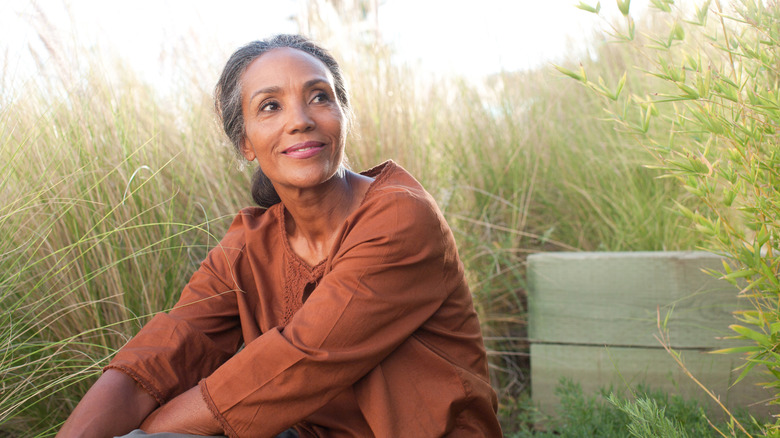 Woman sitting in tall grass